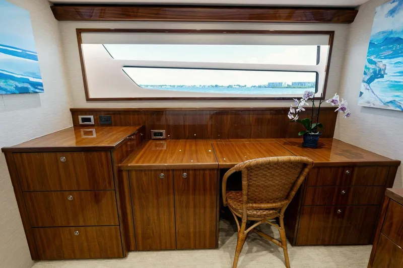Mana Yacht Photos Pics Luxurious wooden desk area in 2021 Viking 82 Cockpit Motor Yacht cabin.