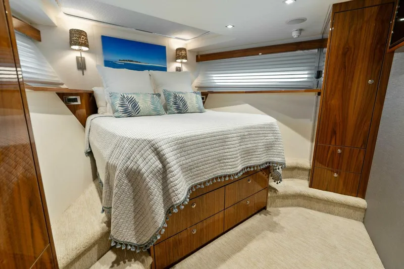 Mana Yacht Photos Pics Luxurious bedroom in 2021 Viking 82 Cockpit Motor Yacht with elegant wood finishes.