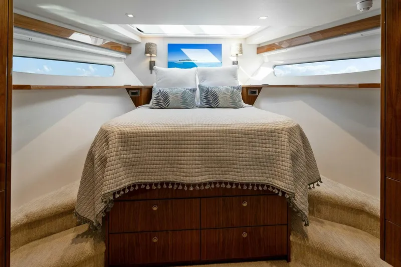 Mana Yacht Photos Pics Luxurious bedroom interior of 2021 Viking 82 Cockpit Motor Yacht with elegant bedding.