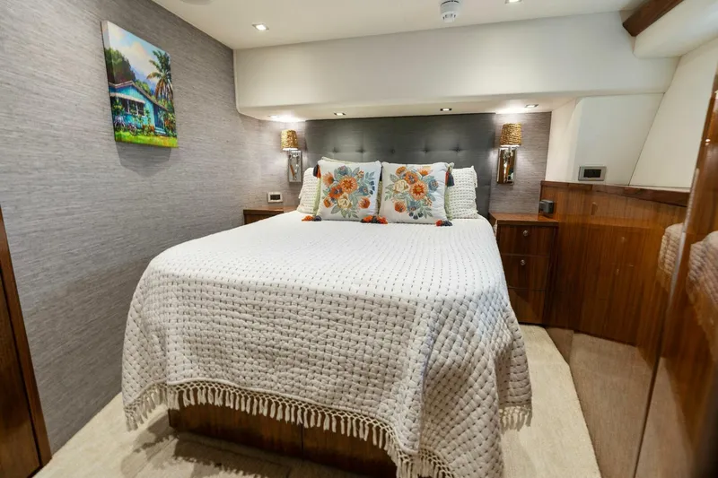 Mana Yacht Photos Pics Luxurious bedroom interior of 2021 Viking 82 Cockpit Motor Yacht with elegant decor.