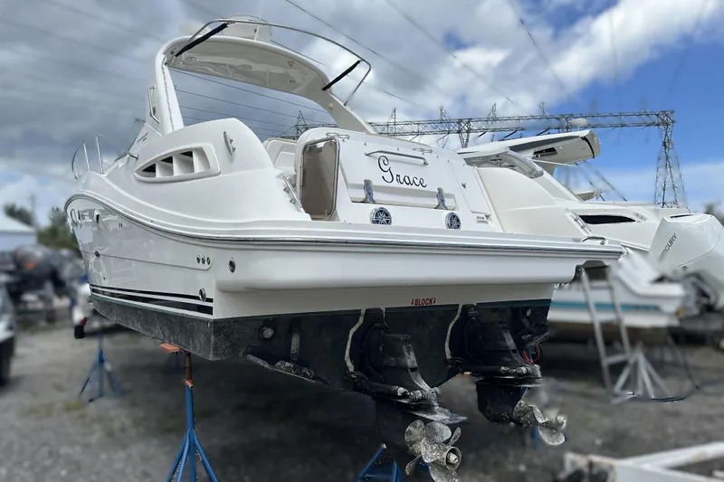  Yacht Photos Pics 2010 Sea Ray 350 Sundancer boat on stands, rear view, cloudy sky background.