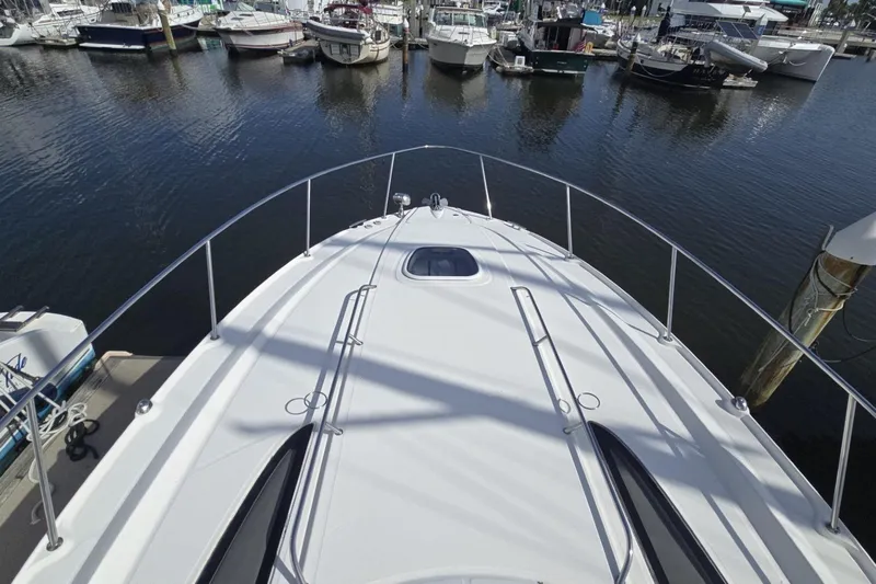  Yacht Photos Pics 2010 Sea Ray 350 Sundancer yacht docked at marina, surrounded by other boats.