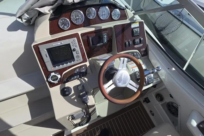  Yacht Photos Pics Cockpit of 2010 Sea Ray 350 Sundancer with steering wheel and navigation controls.