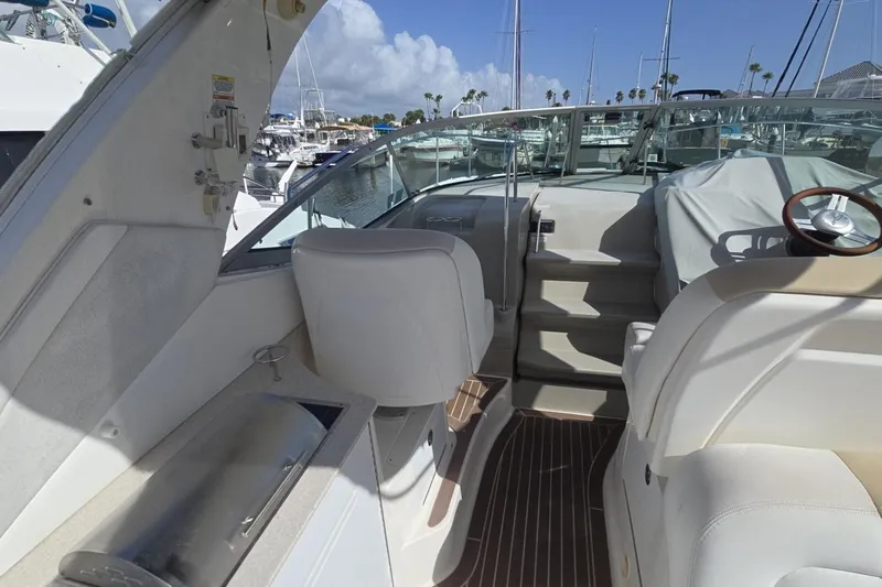  Yacht Photos Pics 2010 Sea Ray 350 Sundancer boat interior with helm, seating, and marina view.