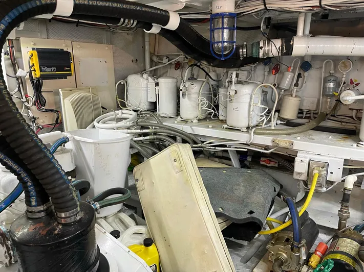  Yacht Photos Pics Engine room of a 1965 Burger 78' Cockpit Flybridge Motor Yacht with various equipment and wiring.