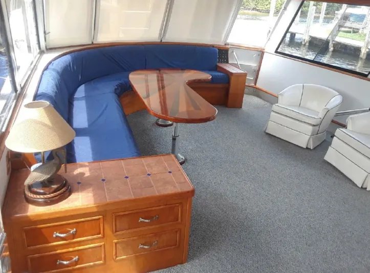  Yacht Photos Pics Interior of 1965 Burger 78' Cockpit Flybridge Motor Yacht with blue seating and wooden furniture.