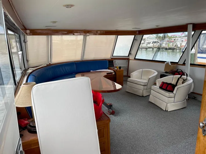  Yacht Photos Pics Interior of 1965 Burger 78' Cockpit Flybridge Motor Yacht with seating area and windows.
