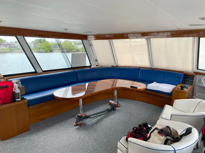  Yacht Photos Pics Interior of 1965 Burger 78' Cockpit Flybridge Motor Yacht with blue seating and wooden table.