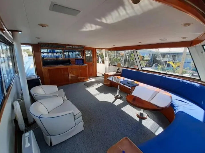 Yacht Photos Pics Interior of 1965 Burger 78' Cockpit Flybridge Motor Yacht with blue seating and wooden accents.