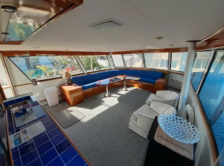  Yacht Photos Pics Interior of 1965 Burger 78' Cockpit Flybridge Motor Yacht with blue seating and panoramic windows.
