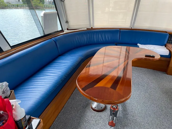 Yacht Photos Pics Interior of 1965 Burger 78' Cockpit Flybridge Motor Yacht with blue seating and wooden table.