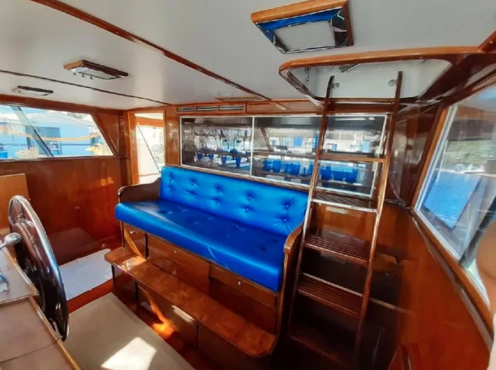  Yacht Photos Pics Interior of 1965 Burger 78' Cockpit Flybridge Motor Yacht with blue seating and wooden finishes.