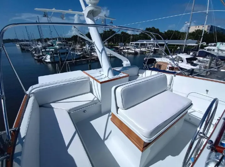  Yacht Photos Pics Flybridge seating area on a 1965 Burger 78' Cockpit Motor Yacht in a marina.
