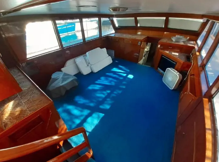  Yacht Photos Pics Interior of 1965 Burger 78' Cockpit Flybridge Motor Yacht with blue carpet and wooden accents.