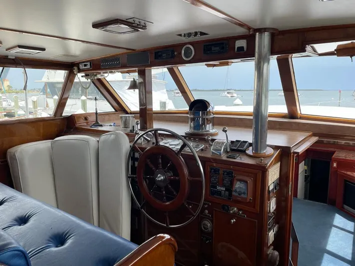  Yacht Photos Pics Interior of 1965 Burger 78' Cockpit Flybridge Motor Yacht with classic wooden helm.
