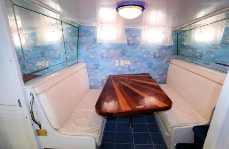  Yacht Photos Pics Cozy dining nook on 1965 Burger 78' Cockpit Flybridge Motor Yacht with nautical wallpaper.