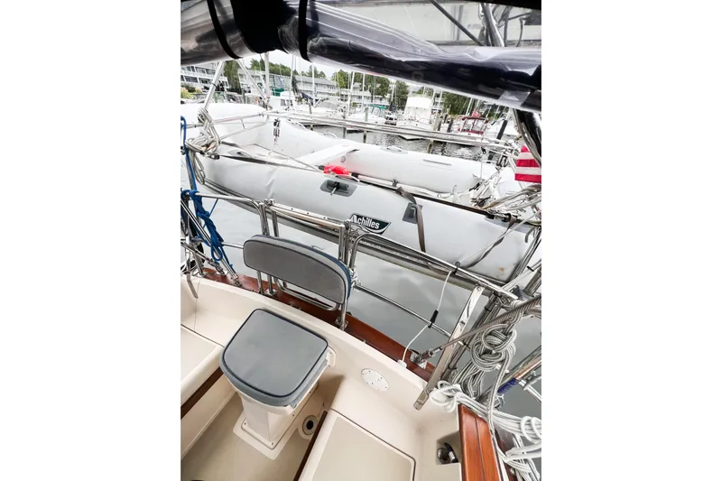 Delicia Yacht Photos Pics 1995 Island Packet 40 sailboat cockpit with docked dinghy and marina view.