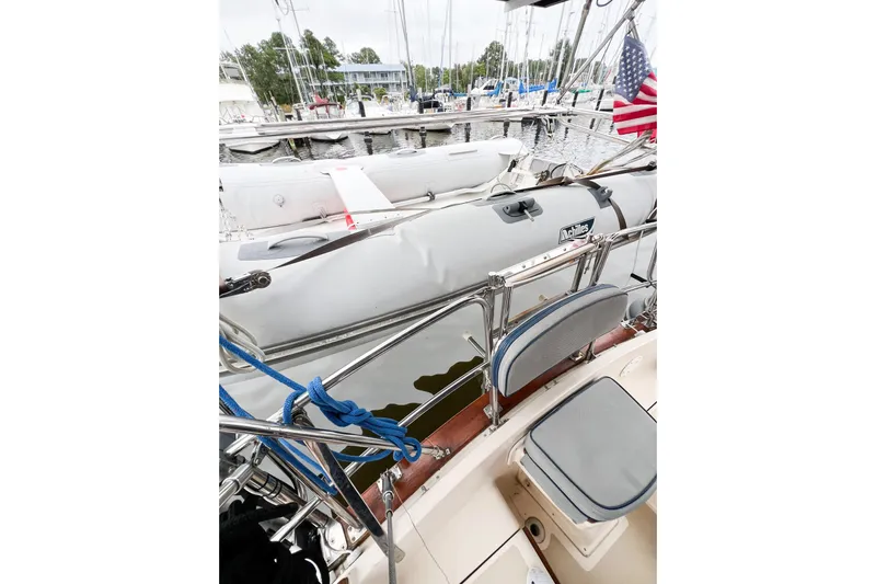Delicia Yacht Photos Pics Island Packet 40 sailboat deck with inflatable dinghy, docked at marina, 1995 model.