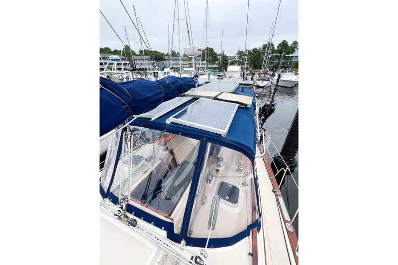 Delicia Yacht Photos Pics 1995 Island Packet 40 sailboat with solar panels docked at a marina.