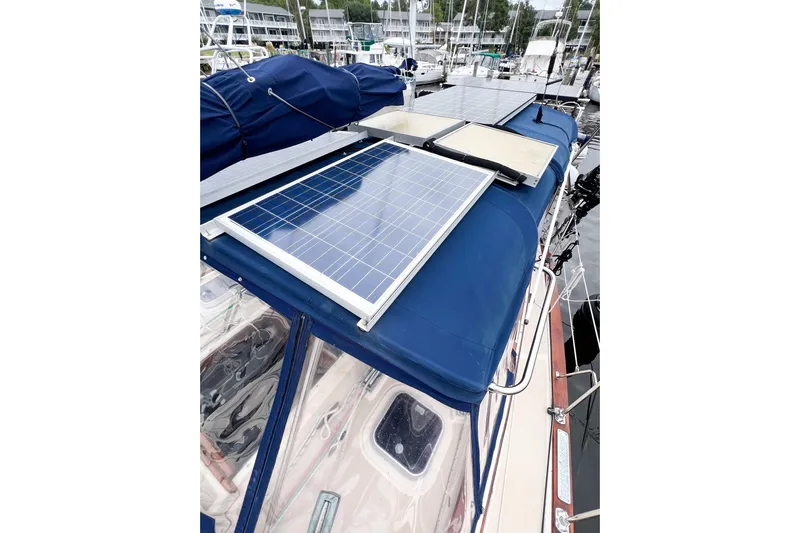 Delicia Yacht Photos Pics 1995 Island Packet 40 sailboat with solar panels on blue canopy.