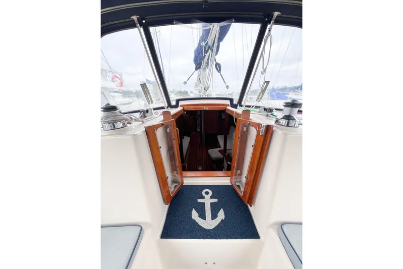 Delicia Yacht Photos Pics Interior view of 1995 Island Packet 40 sailboat with open wooden doors and anchor mat.