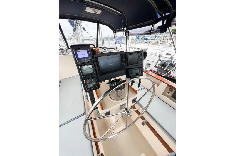 Delicia Yacht Photos Pics Cockpit of 1995 Island Packet 40 sailboat with navigation instruments and steering wheel.