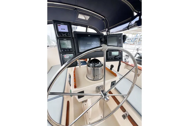 Delicia Yacht Photos Pics Cockpit of 1995 Island Packet 40 sailboat with navigation instruments and steering wheel.
