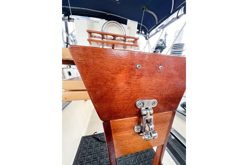 Delicia Yacht Photos Pics Wooden helm station on a 1995 Island Packet 40 sailboat, featuring polished metal fittings.