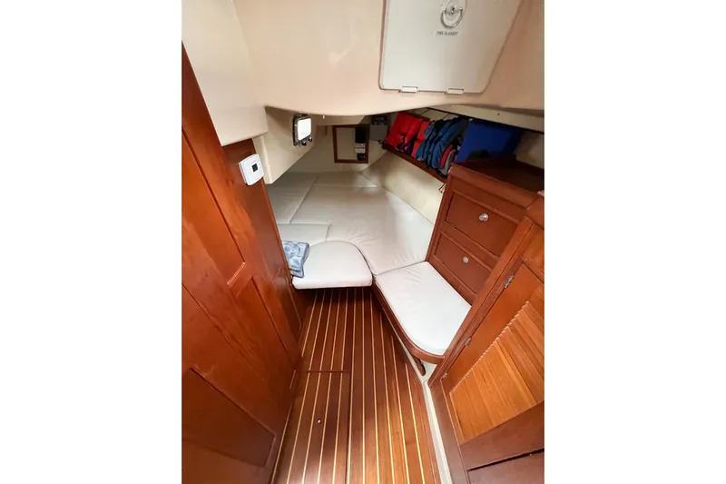 Delicia Yacht Photos Pics Interior of 1995 Island Packet 40 sailboat with wood finish and cozy seating area.