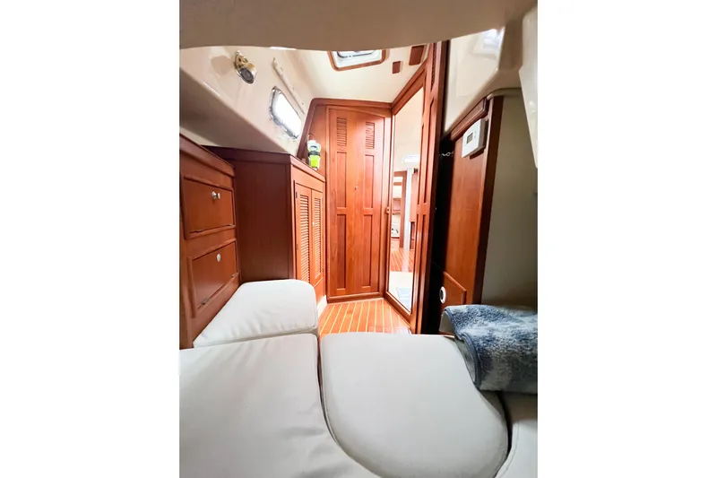 Delicia Yacht Photos Pics Interior of 1995 Island Packet 40 sailboat with wooden cabinetry and cozy seating.