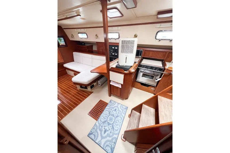 Delicia Yacht Photos Pics Interior of 1995 Island Packet 40 yacht with cozy seating and kitchen area.