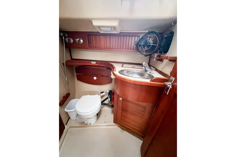 Delicia Yacht Photos Pics 1995 Island Packet 40 yacht bathroom with wooden cabinetry and stainless steel sink.