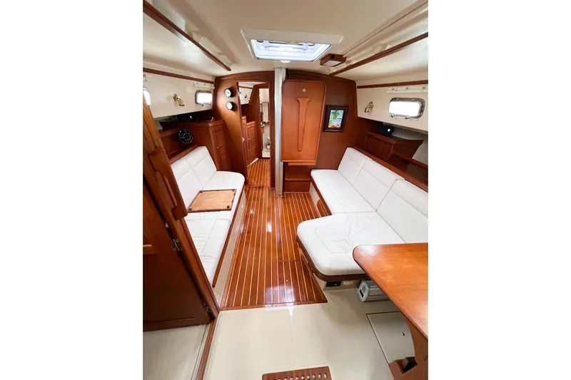 Delicia Yacht Photos Pics Luxurious 1995 Island Packet 40 yacht interior with elegant wood finish and white seating.