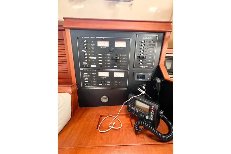 Delicia Yacht Photos Pics Control panel of a 1995 Island Packet 40 sailboat, featuring electrical systems and communication equipment.