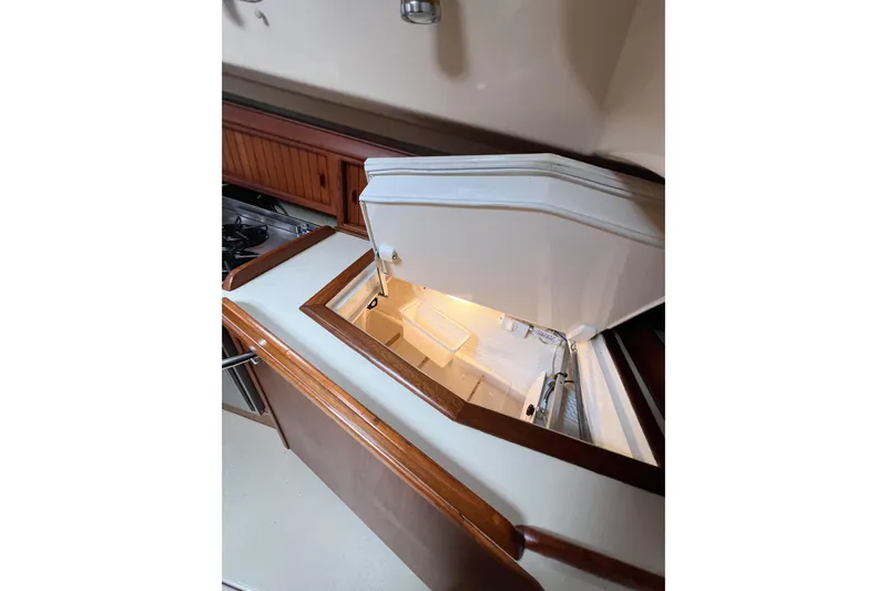 Delicia Yacht Photos Pics 1995 Island Packet 40 yacht interior with open refrigerator in the galley.