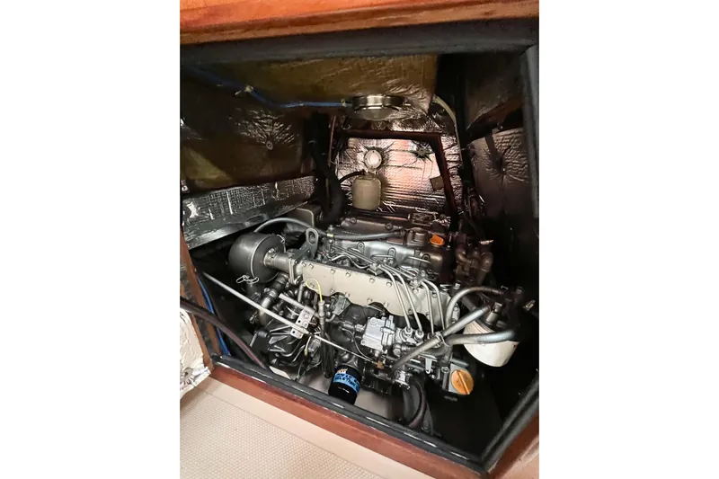 Delicia Yacht Photos Pics Engine compartment of a 1995 Island Packet 40 sailboat, showcasing detailed mechanical components.