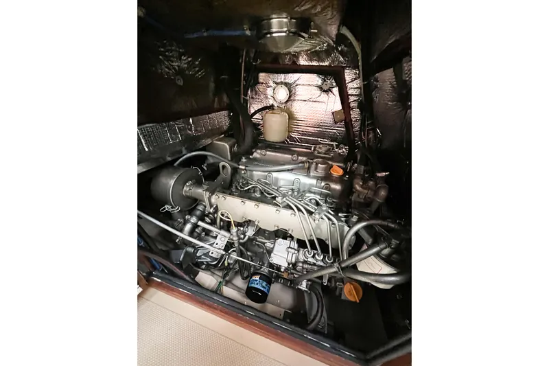 Delicia Yacht Photos Pics Engine compartment of a 1995 Island Packet 40 sailboat, showcasing detailed mechanical components.