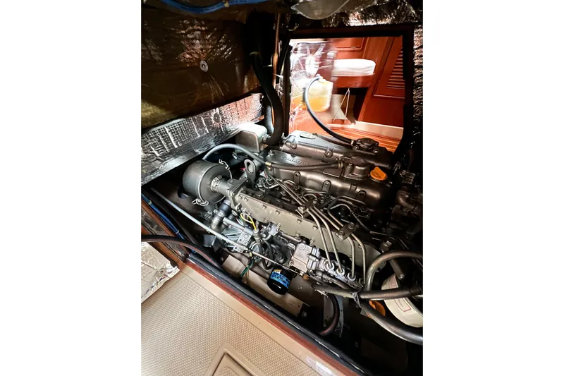 Delicia Yacht Photos Pics Engine compartment of a 1995 Island Packet 40 sailboat, showcasing detailed mechanical components.