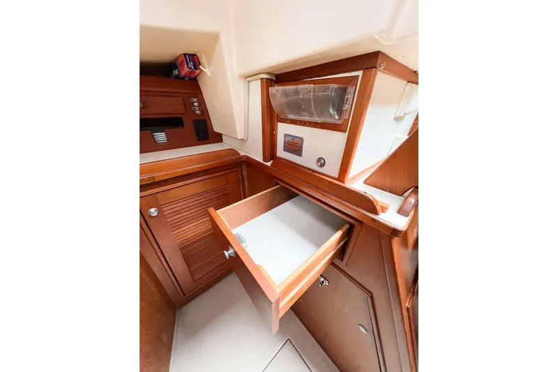 Delicia Yacht Photos Pics Interior of 1995 Island Packet 40 sailboat with open wooden drawer and cabinetry.