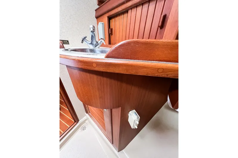 Delicia Yacht Photos Pics Wooden sink area in 1995 Island Packet 40 yacht interior.