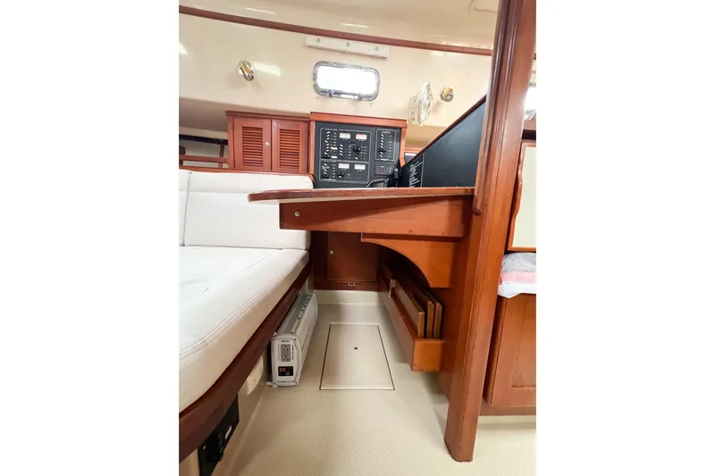 Delicia Yacht Photos Pics 1995 Island Packet 40 interior with navigation station and seating area.