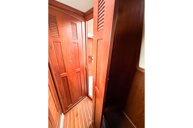 Delicia Yacht Photos Pics Interior of 1995 Island Packet 40 sailboat with wooden cabinetry and flooring.