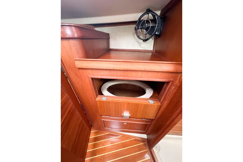 Delicia Yacht Photos Pics 1995 Island Packet 40 interior with wooden cabinetry and fan, showcasing nautical design.