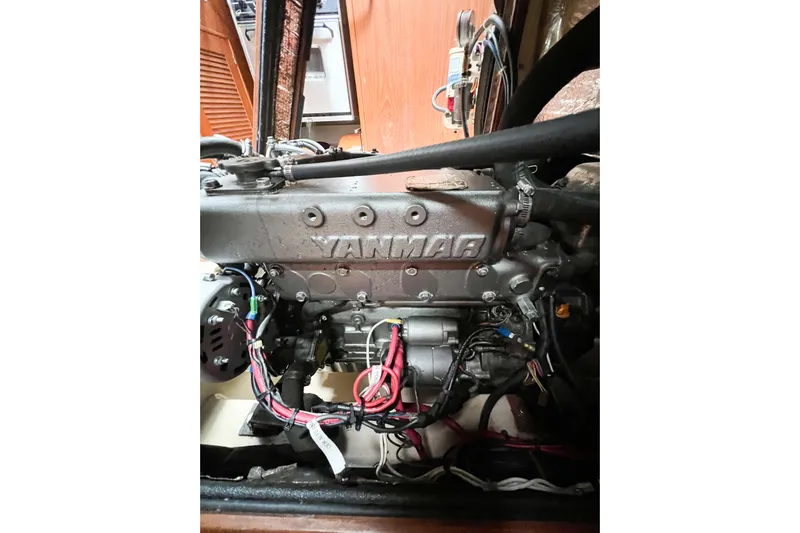 Delicia Yacht Photos Pics Yanmar engine in a 1995 Island Packet 40 sailboat, showcasing detailed wiring and components.
