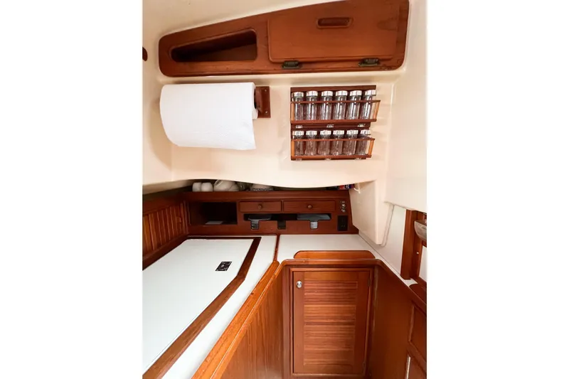 Delicia Yacht Photos Pics Interior of 1995 Island Packet 40 sailboat with wooden cabinetry and spice rack.