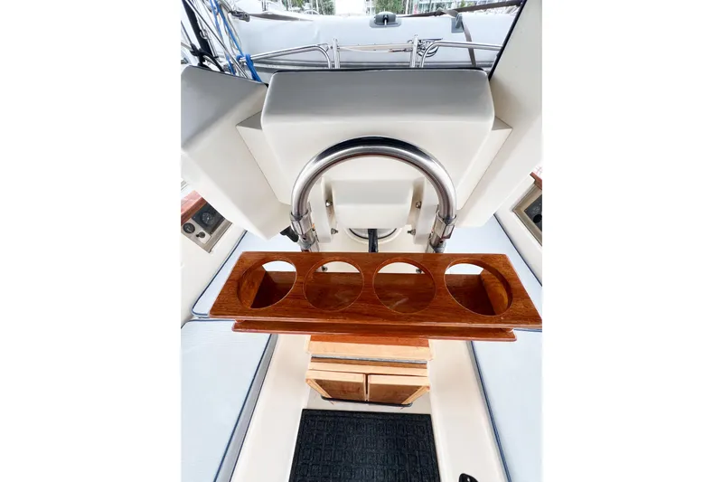 Delicia Yacht Photos Pics Cockpit of 1995 Island Packet 40 sailboat with wooden cup holder and steering wheel.