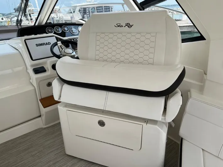  Yacht Photos Pics 2019 Sea Ray Sundancer 350 Coupe helm with white leather seating and Simrad navigation system.
