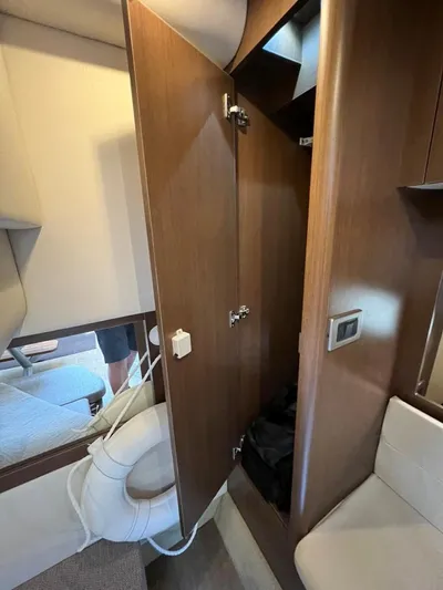  Yacht Photos Pics 2019 Sea Ray Sundancer 350 Coupe interior with wooden cabinetry and seating.