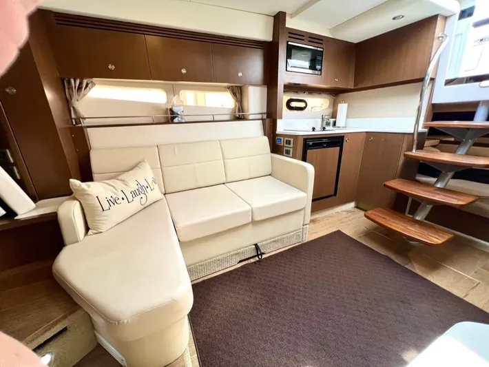  Yacht Photos Pics Interior of 2019 Sea Ray Sundancer 350 Coupe with modern kitchen and cozy seating area.