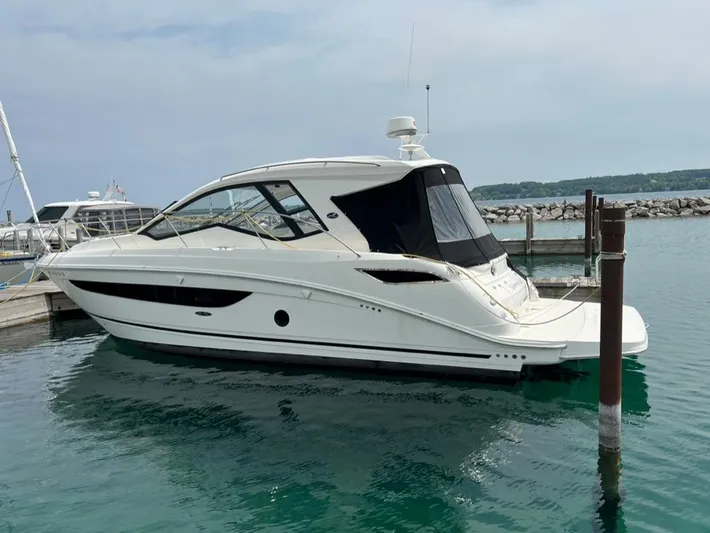  Yacht Photos Pics 2019 Sea Ray Sundancer 350 Coupe docked in a marina, calm water, clear sky.